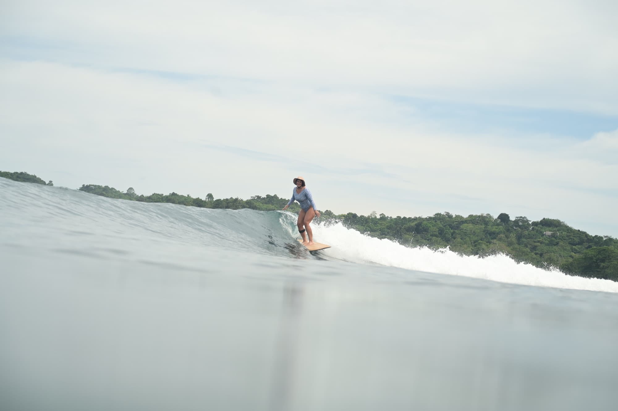 Alana Kane surfing a wave